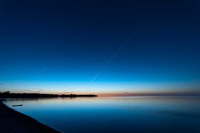 Sunset and jet contrail