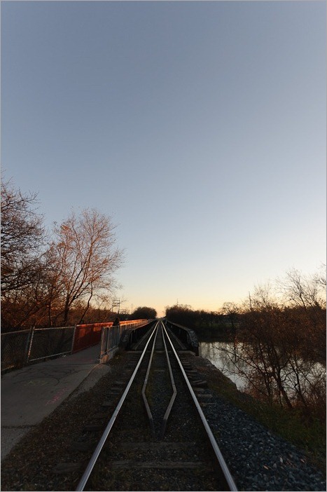 Wide view of a small railway bridge over the Assiniboine
